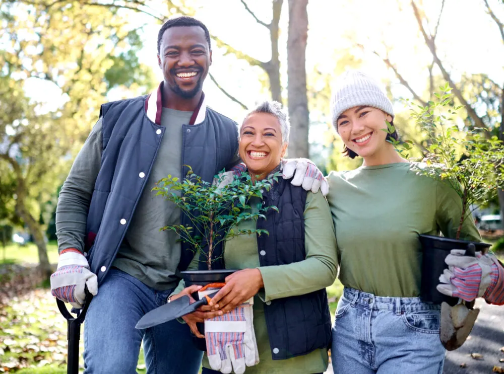 Group of 3 tree planters smiling at the camera